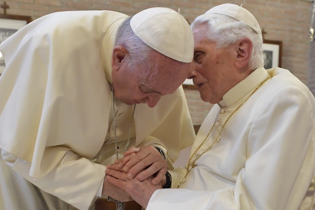 Pope Francis greets greeting Pope Benedict at the Vatican in 2018. The former pope has come out against proposals to end celibacy among priests. File photo: AFP