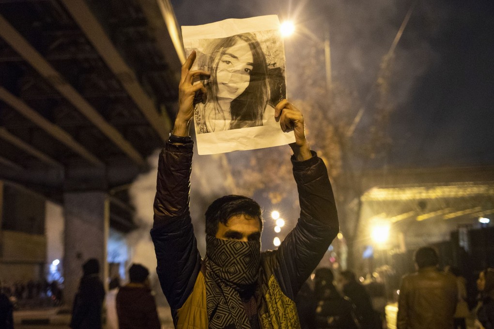 A protester holds a picture of a victim of the Ukrainian Boeing 737 crash as demonstrations broke out after Iran admitted shooting down the passenger jet by mistake, killing all on board. Photo: AFP