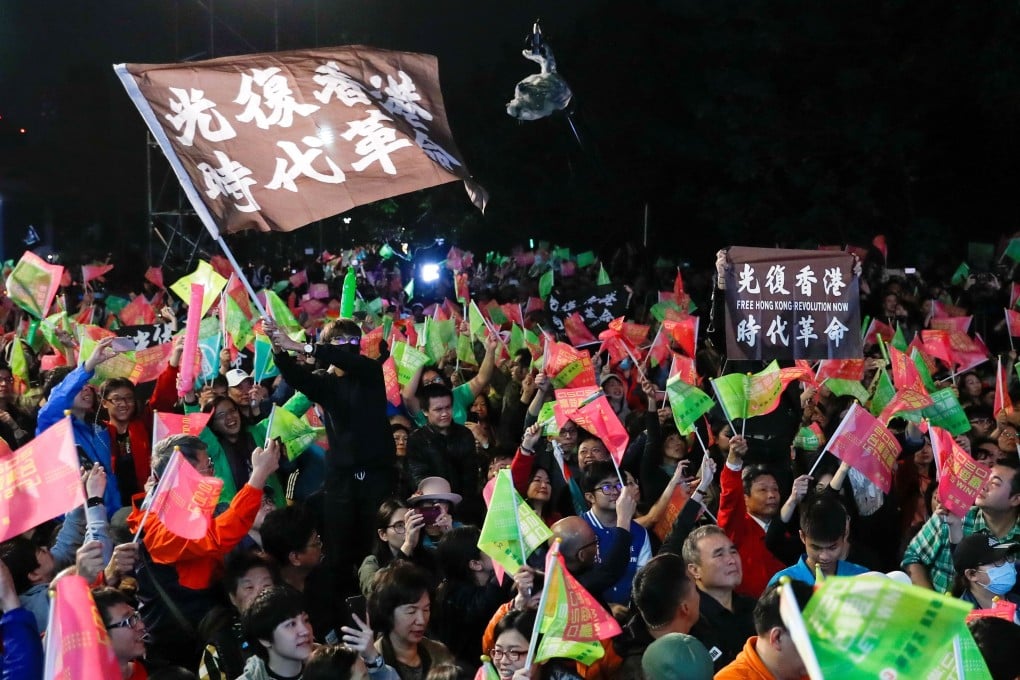 Demonstrators from Hong Kong wave their black protest banners at a rally in support of Taiwan’s President Tsai Ing-wen, outside the Democratic Progressive Party headquarters in Taipei on January 11. Photo: Reuters