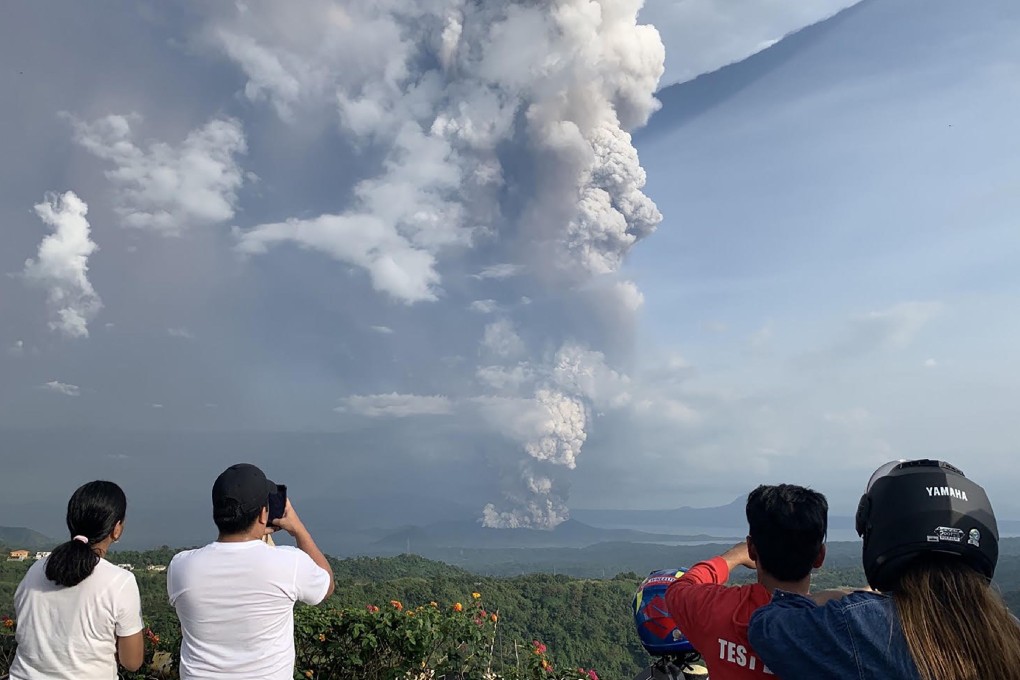 People photograph the Taal volcano from Tagaytay, southwest of Manila. Photo: AFP