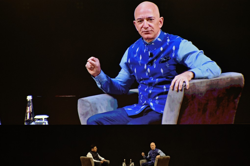 Jeff Bezos, founder and chief executive of Amazon.com, right, speaks as Amit Agarwal, head of Amazon India, listens during the opening session of the company’s Sambhav event in New Delhi on January 15. Photo: Bloomberg