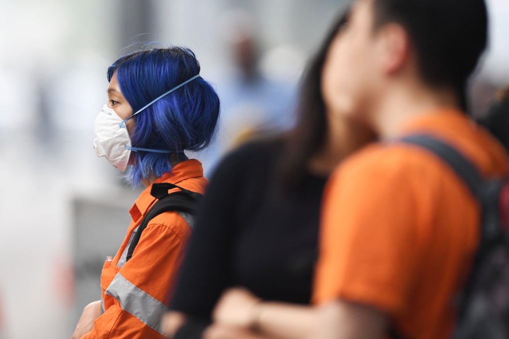 A pedestrian in Melbourne wears a face mask to protect herself from haze triggered by devastating bush fires across the Australian states of Victoria and New South Wales, on January 14. Photo: AAP Image/DPA