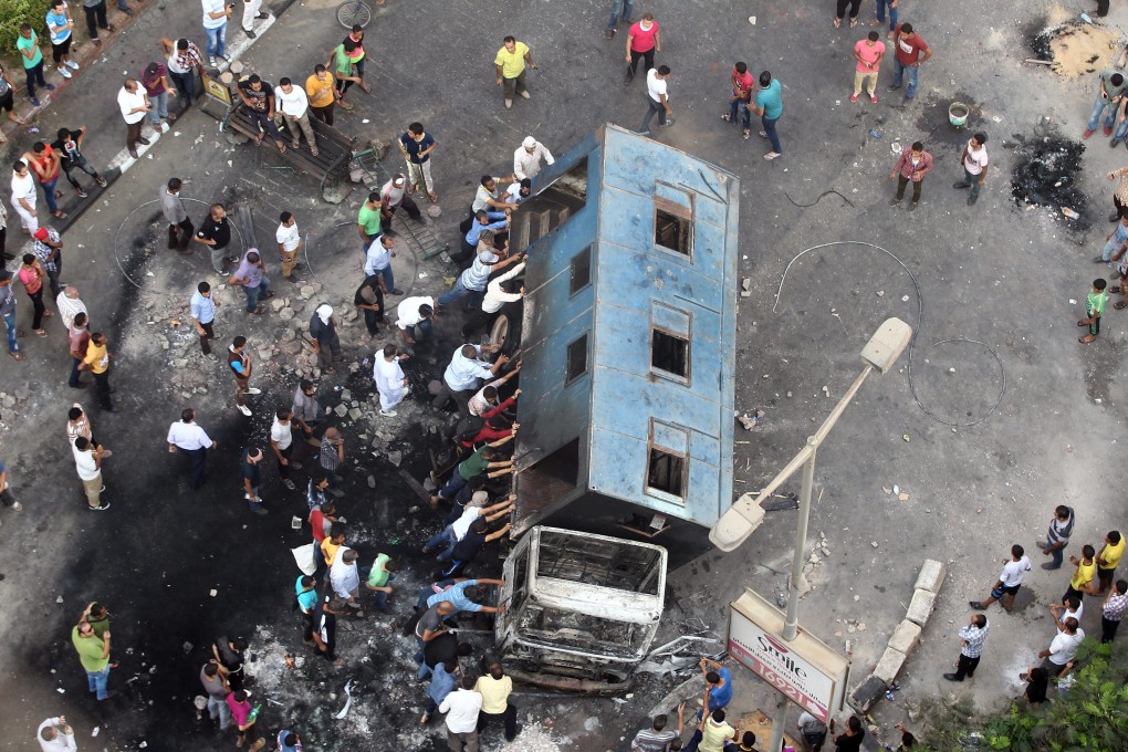Egyptian supporters of ousted President Mohammed Mursi push over a truck during protests in Giza, near Cairo, on August 14, 2013. File photo: EPA