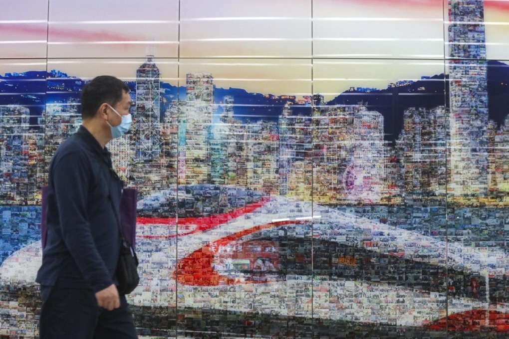 A man in a mask walks outside the West Kowloon terminus of the high-speed rail in Hong Kong, with trains to the mainland city of Wuhan, where a new form of pneumonia has gripped the population. Photo: K.Y. Cheng