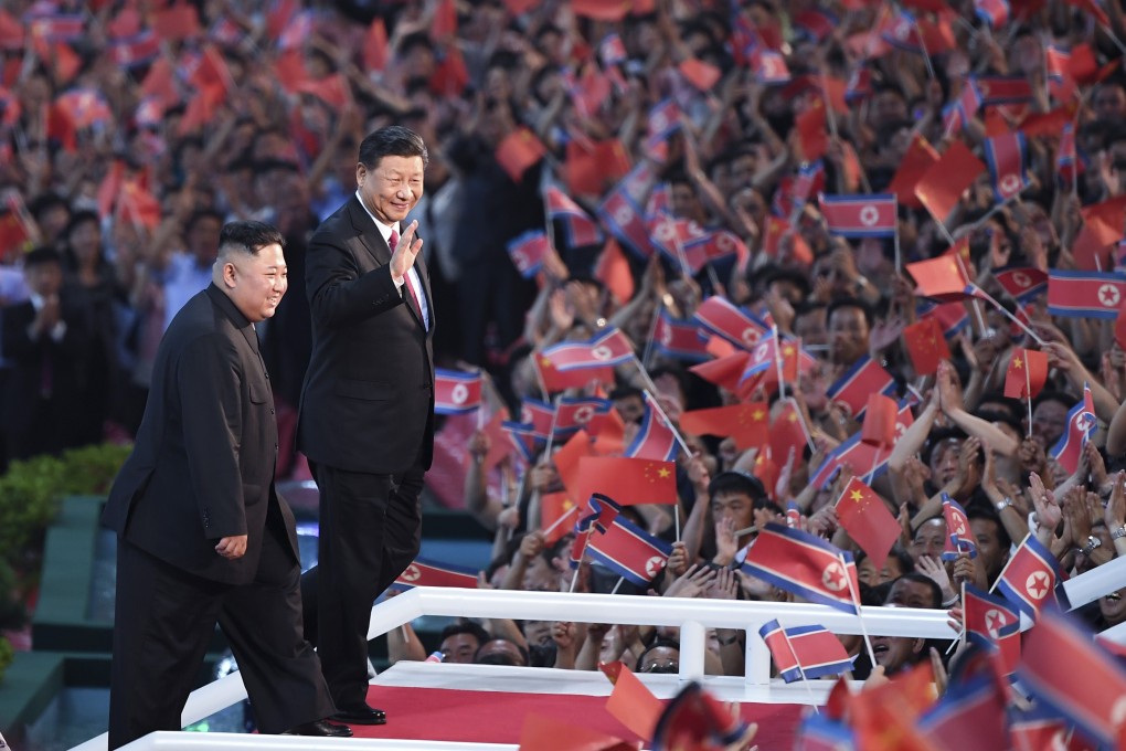 Chinese President Xi Jinping and North Korean leader Kim Jong-un greet the crowds at a performance at the May Day Stadium in Pyongyang on June 20. Beijing’s mediation of nuclear talks would help promote its status as a responsible power on the world stage. Photo: Xinhua