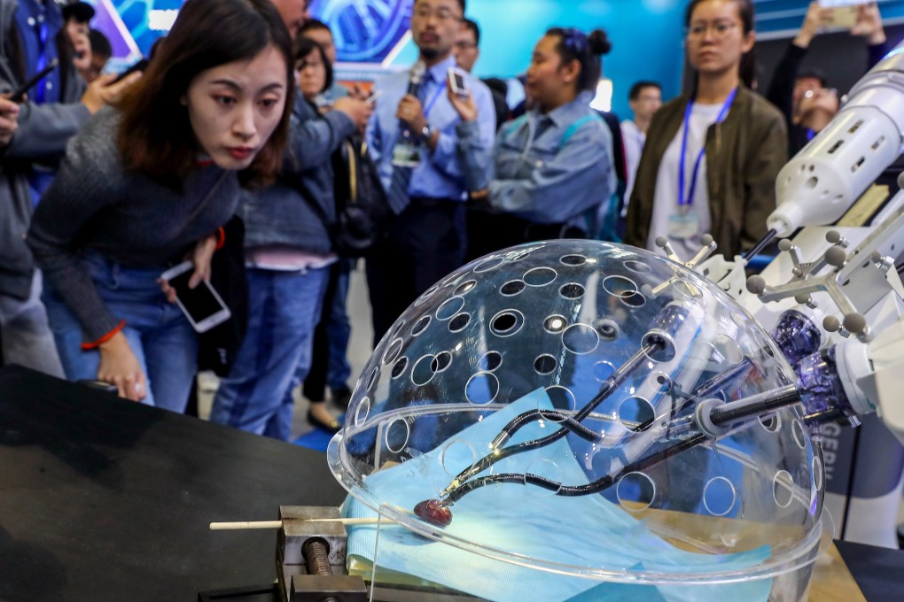 Members of the media look at a robot system for porotic laparoscopic surgery during a preview of the National Mass Innovation and Entrepreneurship Week in Beijing in October 2018. The US has criticised China for intellectual property theft. Photo: Xinhua
