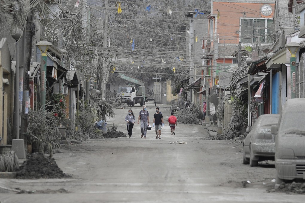 Animal volunteers search for pets left by owners in a deserted village. Photo: AP