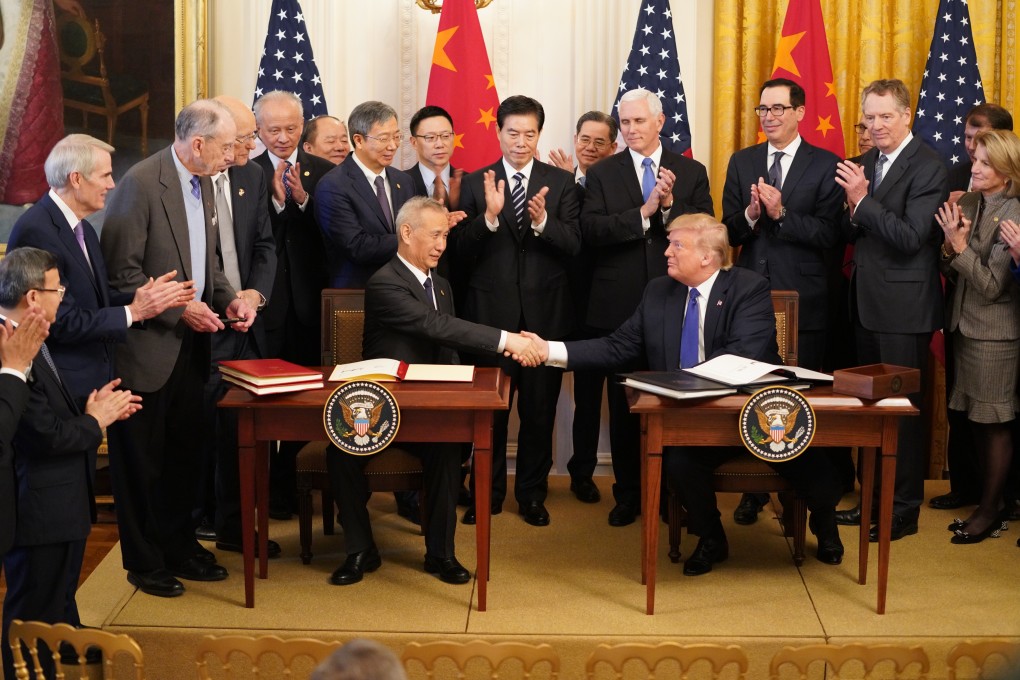 Chinese Vice-Premier Liu He and US President Donald Trump at the White House on Wednesday. A phase one trade deal signed between the world’s two largest economies will benefit China’s stock markets, analysts say. Photo: Xinhua