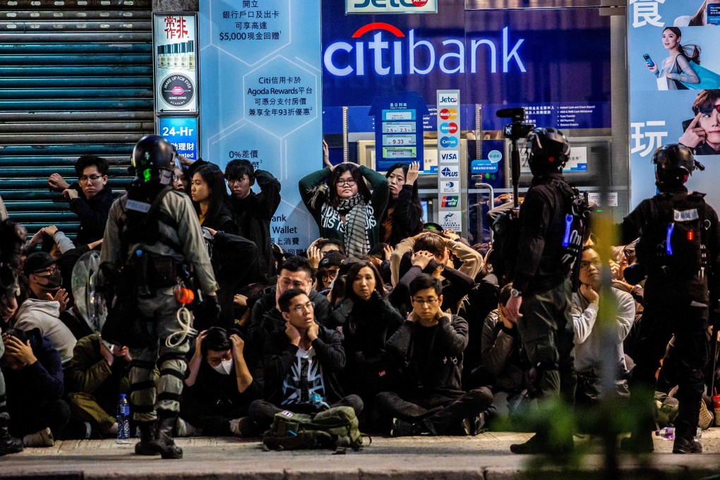 Police detain a group of people after a pro-democracy march in Hong Kong on January 1. Photo: AFP