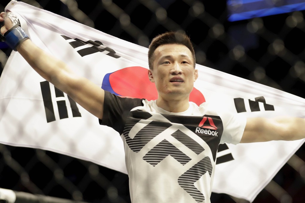 Jung Chan-sung celebrates with his native flag after defeating Dennis Bermudez in 2017. Photo: AFP