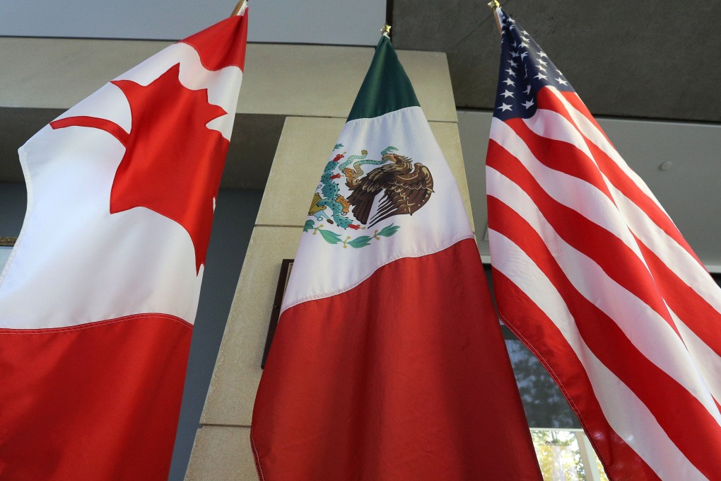 The Canadian, Mexican and US flags hang in the lobby during trade negotiations in Ottawa in September 2017. Photo: AFP