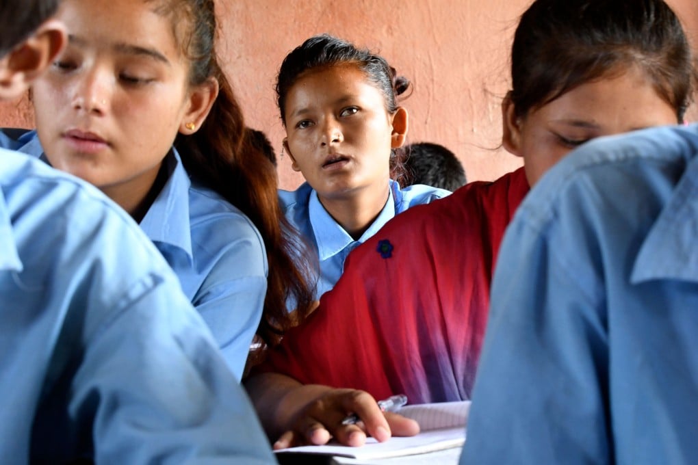 Child marriage survivor Aradhana Nepal, centre, attends a class in Surkhet District, 520km west of Kathmandu. Photo: AFP