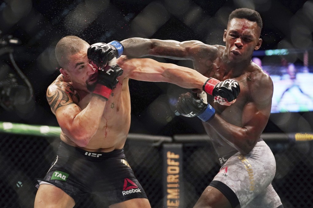 Robert Whittaker is hit by Israel Adesanya at UFC 243 in Melbourne. Photo: AP