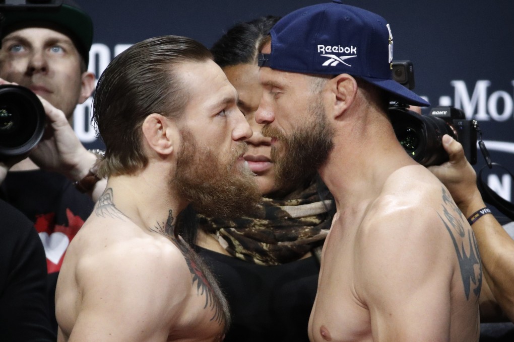Conor McGregor (left) stares down Donald ‘Cowboy’ Cerrone during a ceremonial weigh-in for UFC 246. Photo: AP