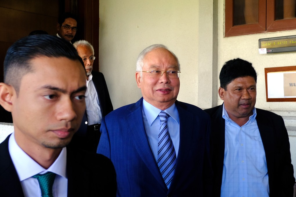 Najib Razak, Malaysia's former prime minister, centre, leaves a courtroom at the Kuala Lumpur Courts Complex. Photo: Bloomberg
