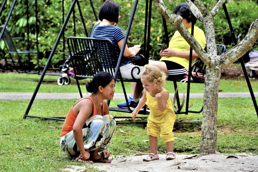 A domestic helper watches over her charge in Singapore. Photo: Shutterstock