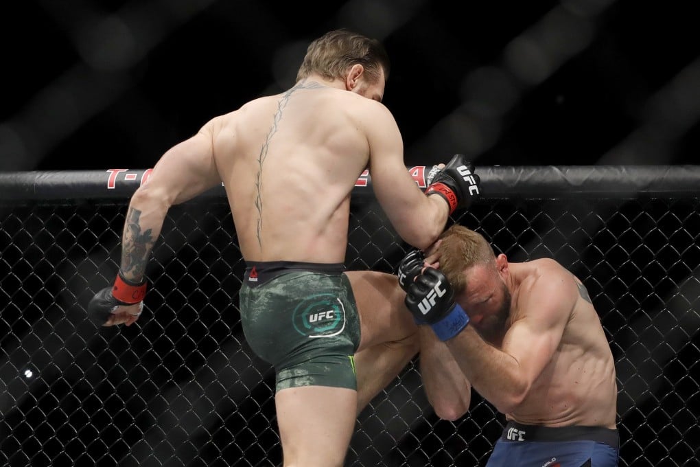Conor McGregor lands a flying knee to the face of Donald Cerrone. Photo: AFP