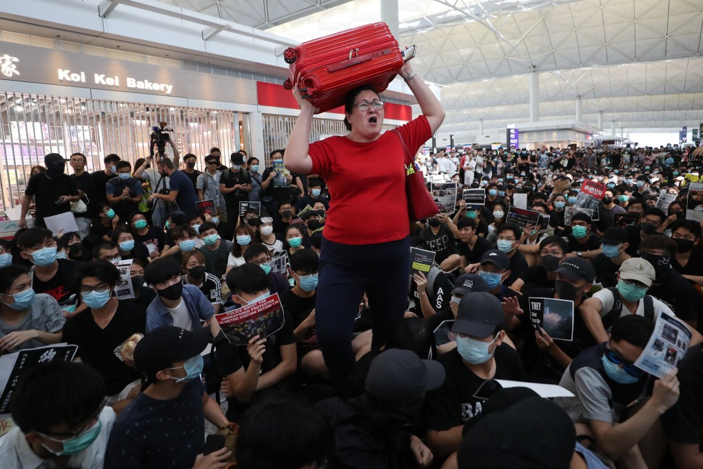 A traveller loses patience with protesters at Hong Kong airport, who occupied the site in August. Photo: Sam Tsang