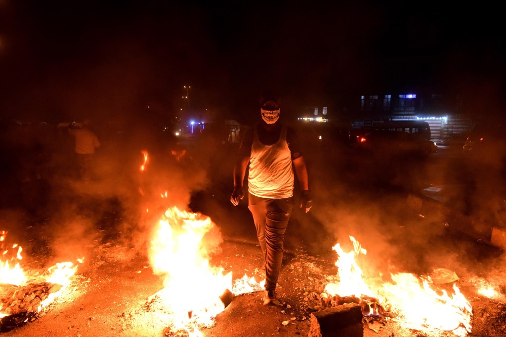 Iraqi protesters set fire to block a street during a strike and anti-government demonstrations. Photo: EPA-EFE