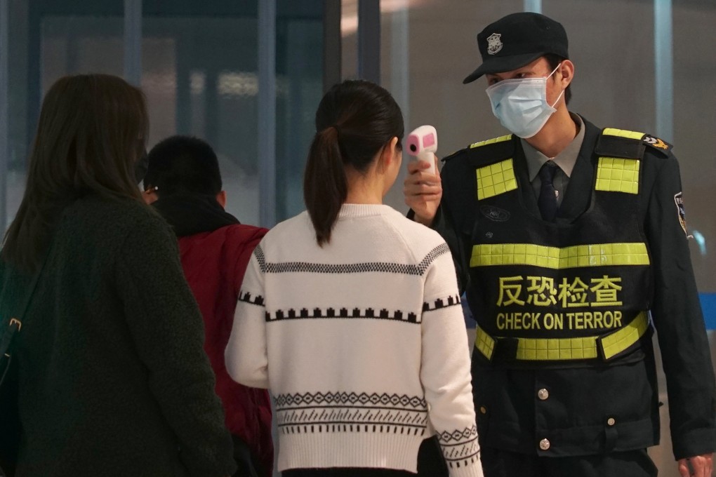 A passenger has her temperature checked at Wuhan’s airport on Tuesday. The virus outbreak began in the city in December. Photo: AP