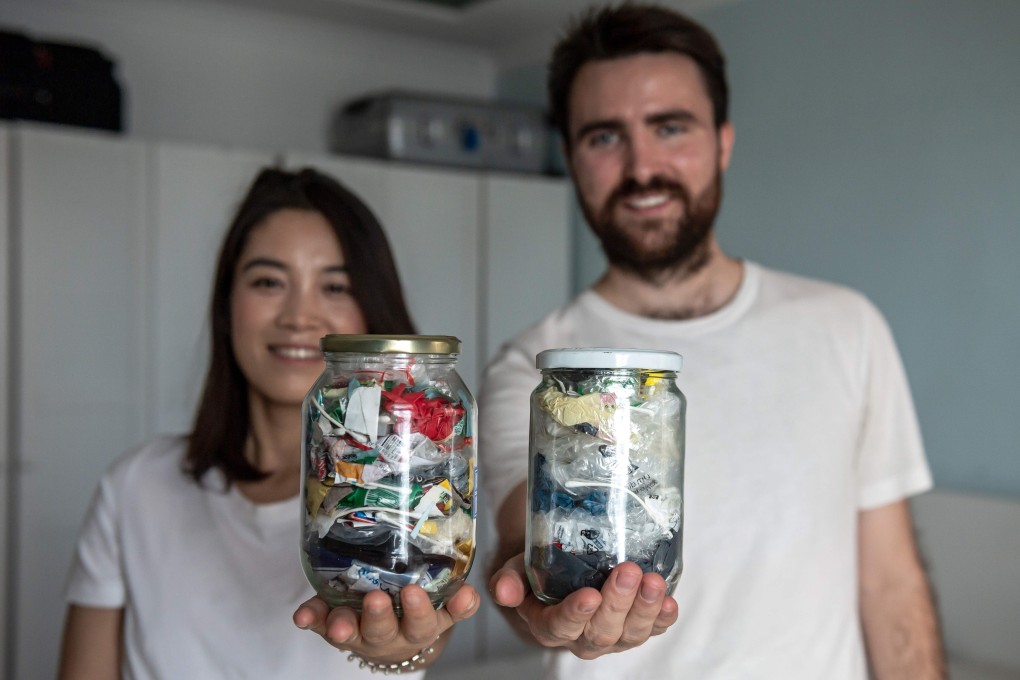Beijing couple Carrie Yu and Joe Harvey, founders of zero-waste shop The Bulk House, with jars containing all of their personal waste collected over three months. Photo: AFP