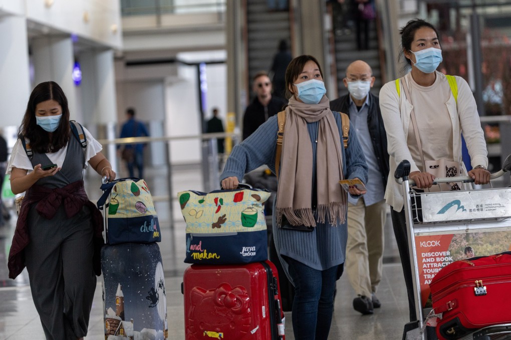 Travellers wear masks in the arrival hall of Hong Kong International Airport on Wednesday as China confirmed 440 cases of Wuhan pneumonia with nine deaths. Photo: EPA