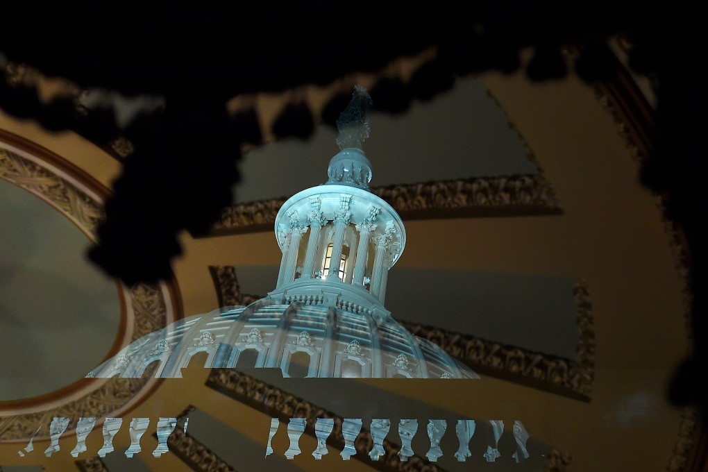 The dome of the US Capitol reflected in a window outside the chamber, as senators meet for the first full day in the impeachment trial of US President Donald Trump on January 21. Photo: AFP