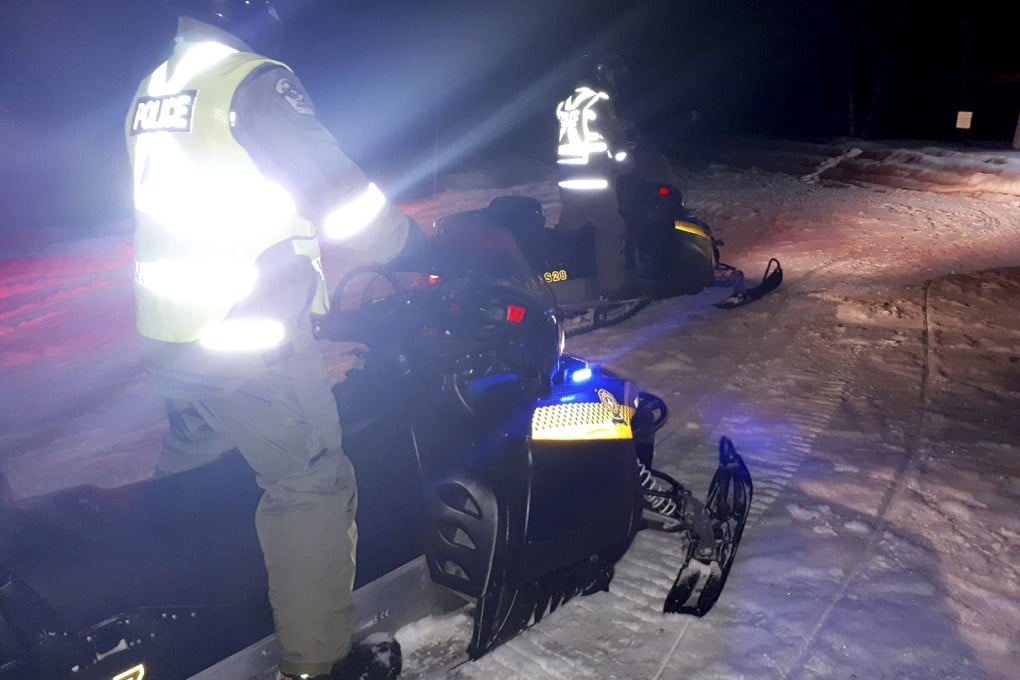 Police on snowmobiles during search the area for the missing tourists. Photo: AFP