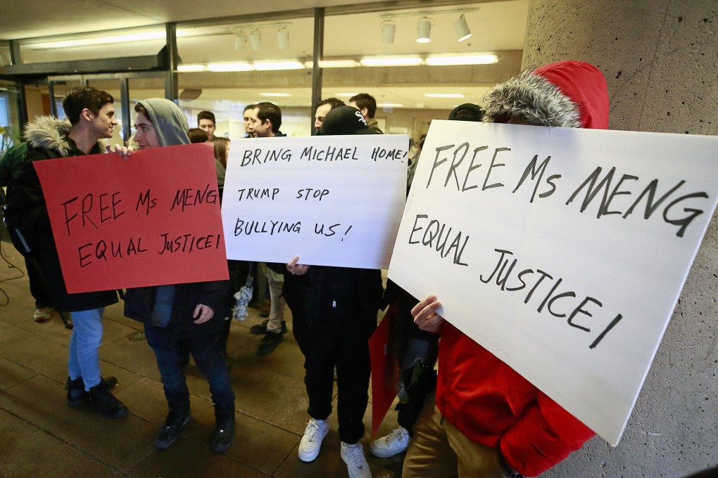 Apparent supporters of Huawei executive Meng Wanzhou protest outside the British Columbia Supreme Court on Monday. Photo: AFP