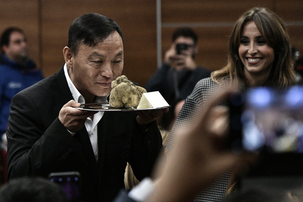 A Chinese buyer smelling a white truffle he bought at the 19th Alba White Truffle World Auction in November 2018. Photo: AFP