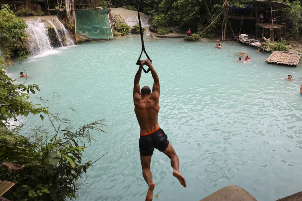 A tourist goes down a zip-line at Cambugahay waterfalls in Siquijor, Central Visaya, Philippines. Not all adventure holidays have to be this exciting. Photo: James Wendlinger