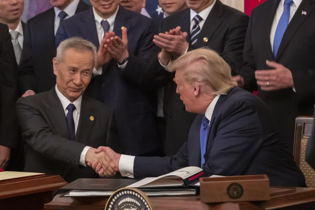 Chinese Vice Premier Liu He and US President Donald Trump sign the trade agreement on January 15. Photo: EPA