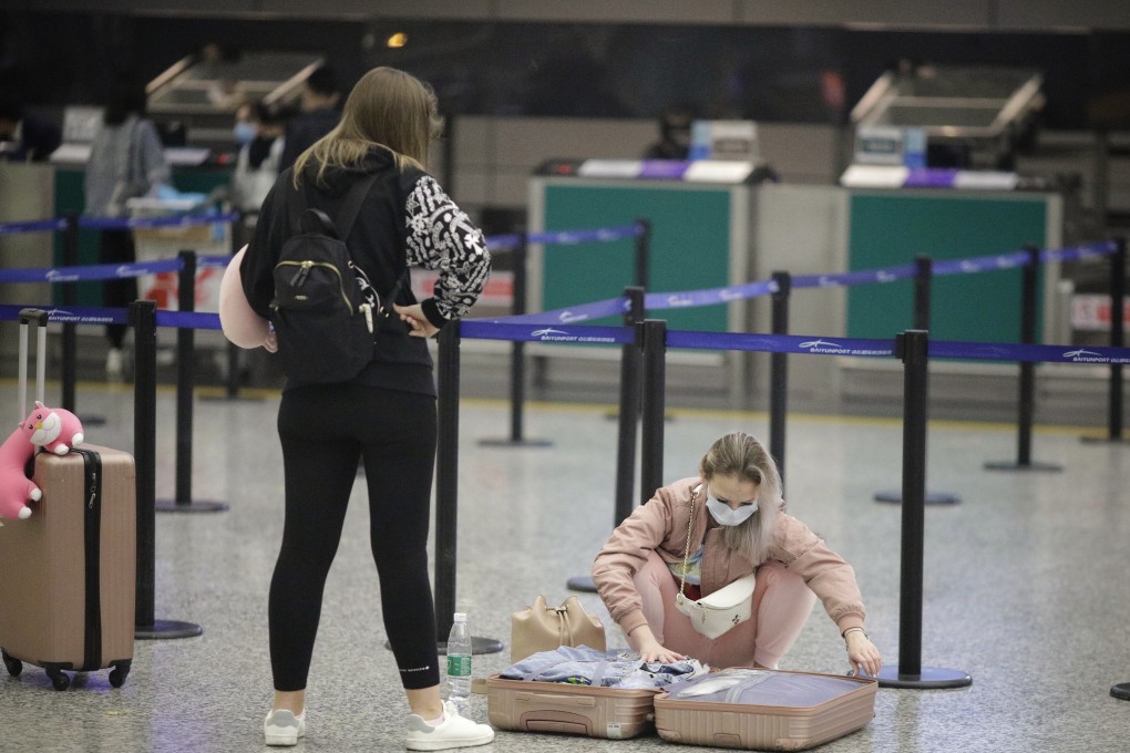Passengers wear masks at Guangzhou airport as a precaution against the outbreak of coronavirus that originated in Wuhan. Photo: EPA-EFE