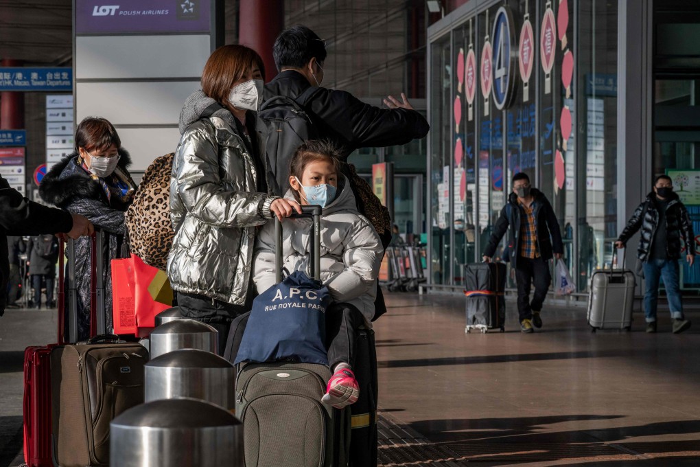Travellers wearing masks as they head for the departure hall at Beijing Capital International Airport on January 22. Photo: AFP