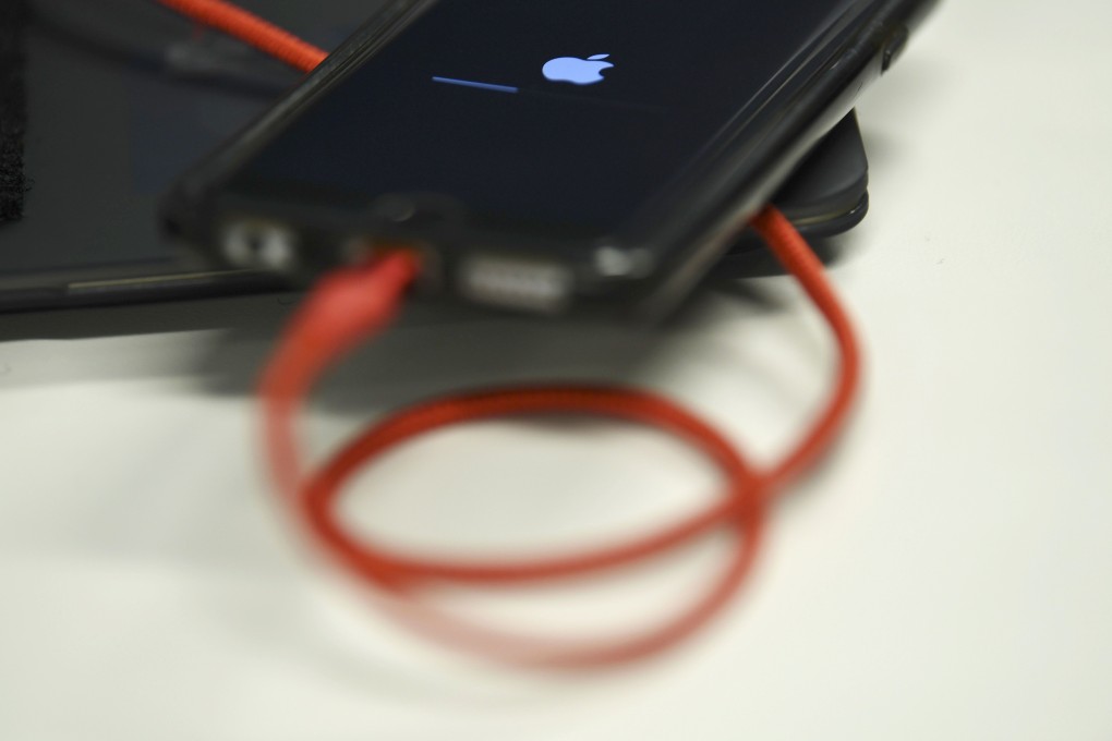An iPhone 6S is plugged into a battery charger in Washington, DC. File photo: AFP
