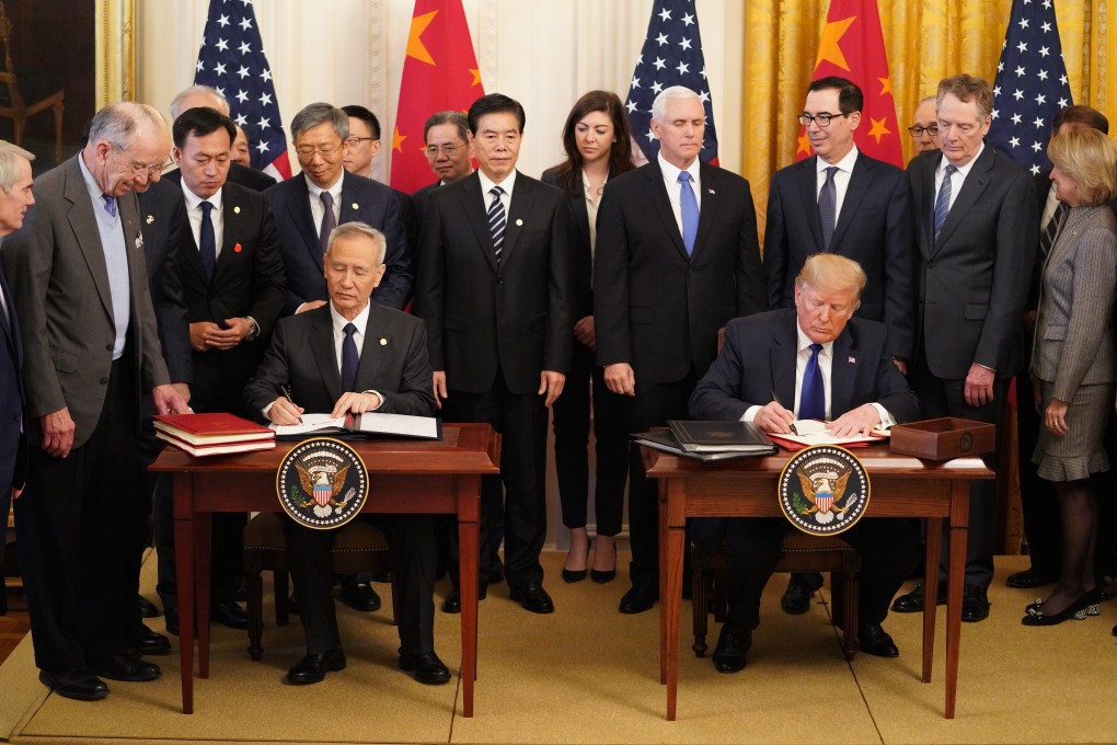Chinese Vice-Premier Liu He and US President Donald Trump signing the phase-one trade agreement at the White House in Washington on January 15. Even with the deal now done, American businesses remain unsure whether to invest in China. Photo: Xinhua