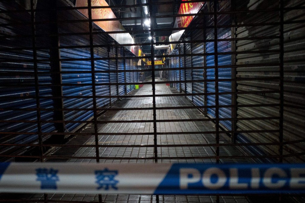 Members of the Wuhan Hygiene Emergency Response Team conduct searches in the shuttered Huanan Seafood Wholesale Market in Wuhan, Hubei province, on January 11. Photo: AFP