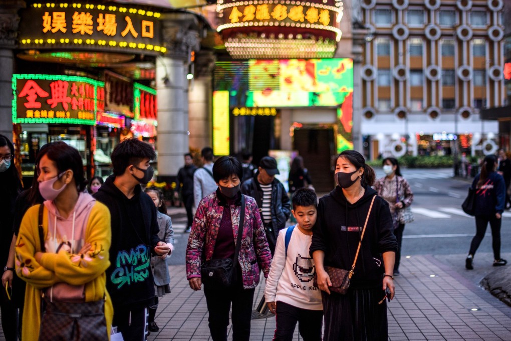 Pedestrians wear face masks in Macau on January 22, after the former Portuguese colony reported its first case of the new coronavirus that originated from Wuhan in mainland China. Photo: AFP