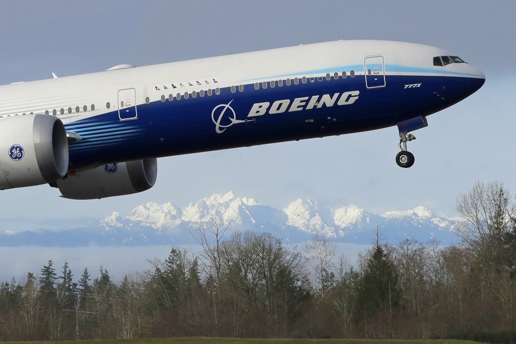 A Boeing 777X plane takes off on its first flight at Paine Field in Everett, Washington state, with the Olympic Mountains in the background. Photo: AP
