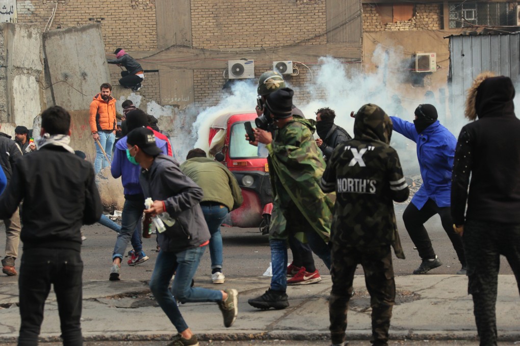 Smoke rise from tear gas fired by security forces during clashes with anti-government protesters in Baghdad on Saturday. Photo: AP