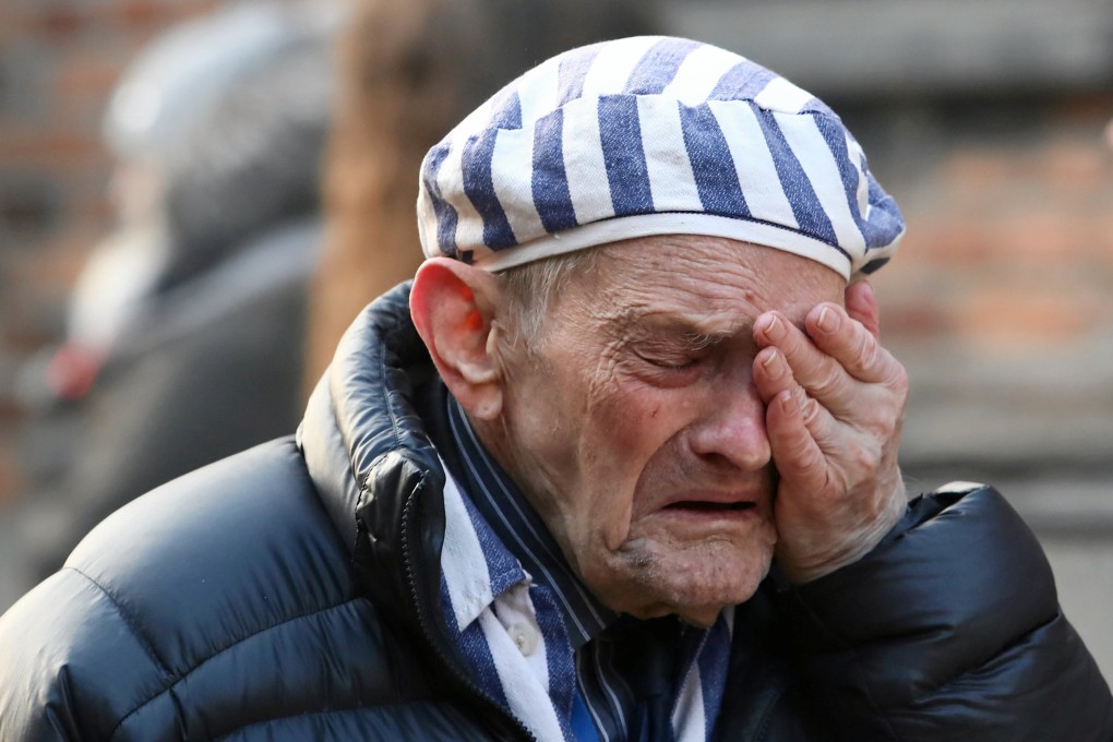 A survivor wipes away tears during a wreath-laying ceremony at the former Nazi German concentration and extermination camp Auschwitz. Photo: Reuters