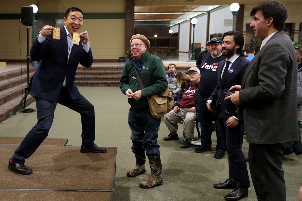 Andrew Yang receives a lai see packet from a supporter during a town hall meeting in Oskaloosa, Iowa. Photo: AFP