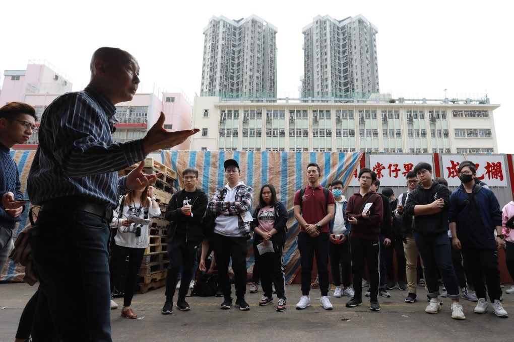 Jimmy Wong (left) leads school pupils on a guided tour. Photo: May Tse