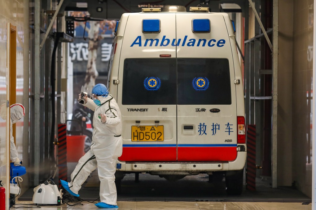 An ambulance crew and their vehicle undergo disinfection procedures in the coronavirus-hit city of Wuhan in central China. Photo: EPA-EFE
