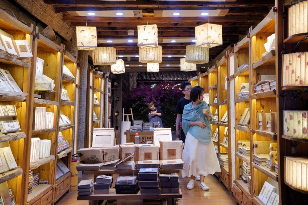 Shoppers browse what’s on offer in a store in Lijiang, Yunnuan province. The Chinese economy has a very high national savings rate, and with banks being the main financial intermediaries, China’s debt levels are naturally higher than those of most other countries. Photo: Xinhua