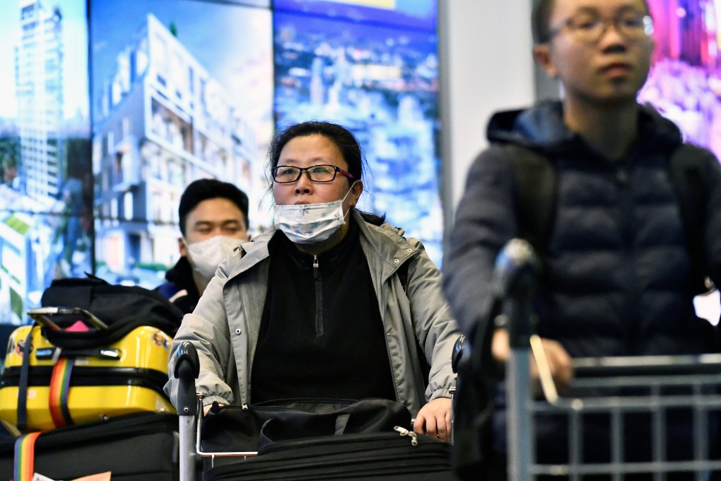 Travellers, some wearing masks, arrive at Vancouver International Airport after a flight from China. Photo: Reuters