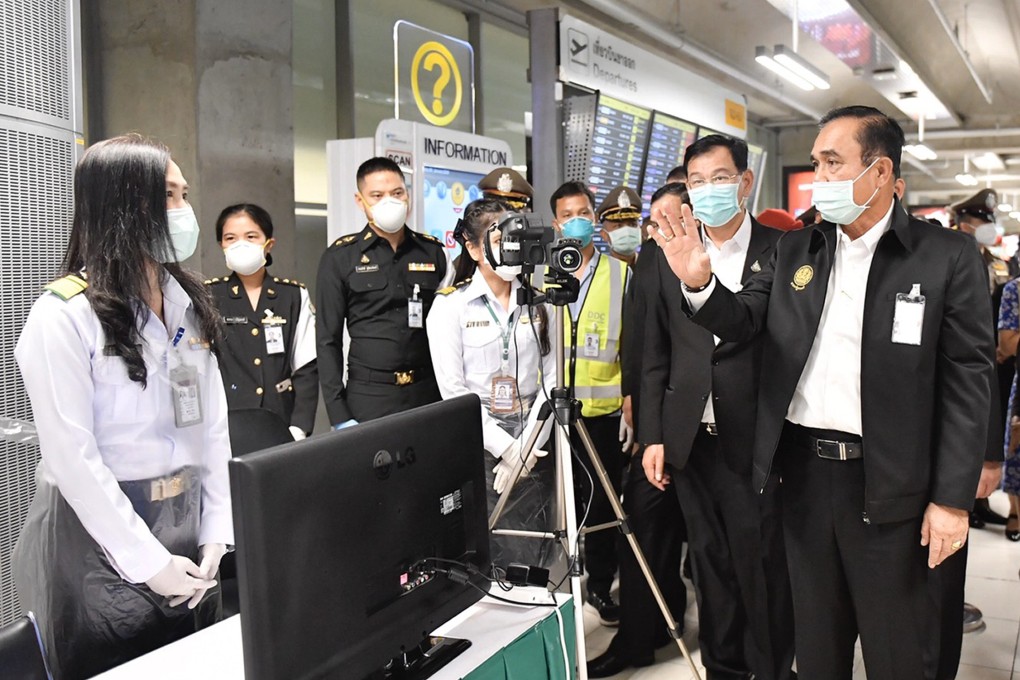 Thailand's Prime Minister Prayuth Chan-ocha talks to officials as he visits the patient screening point at Suvarnabhumi Airport in Bangkok. Officials have stepped up monitoring and inspection for the new coronavirus. Photo: EPA-EFE