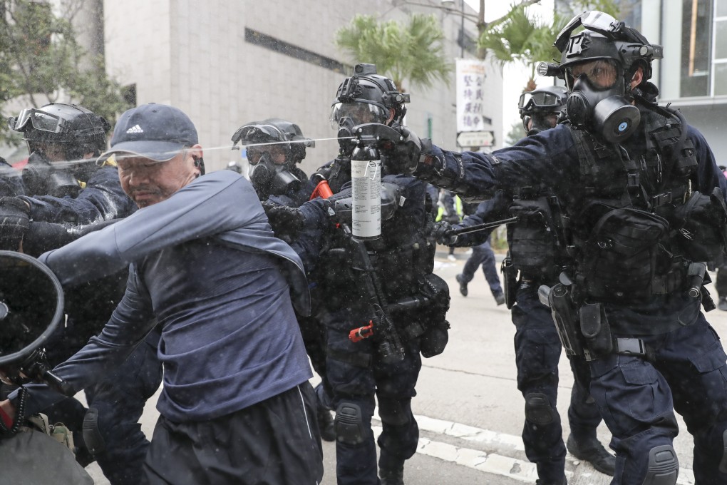 A police officer fires pepper spray at an anti-government protester during a rally in Central. Photo: Sam Tsang