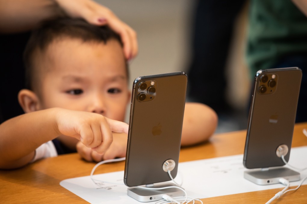 A child tries an iPhone 11 Pro Max smartphone during a product launch at an Apple Store in Hong Kong on September 20, 2019. Photo: Bloomberg