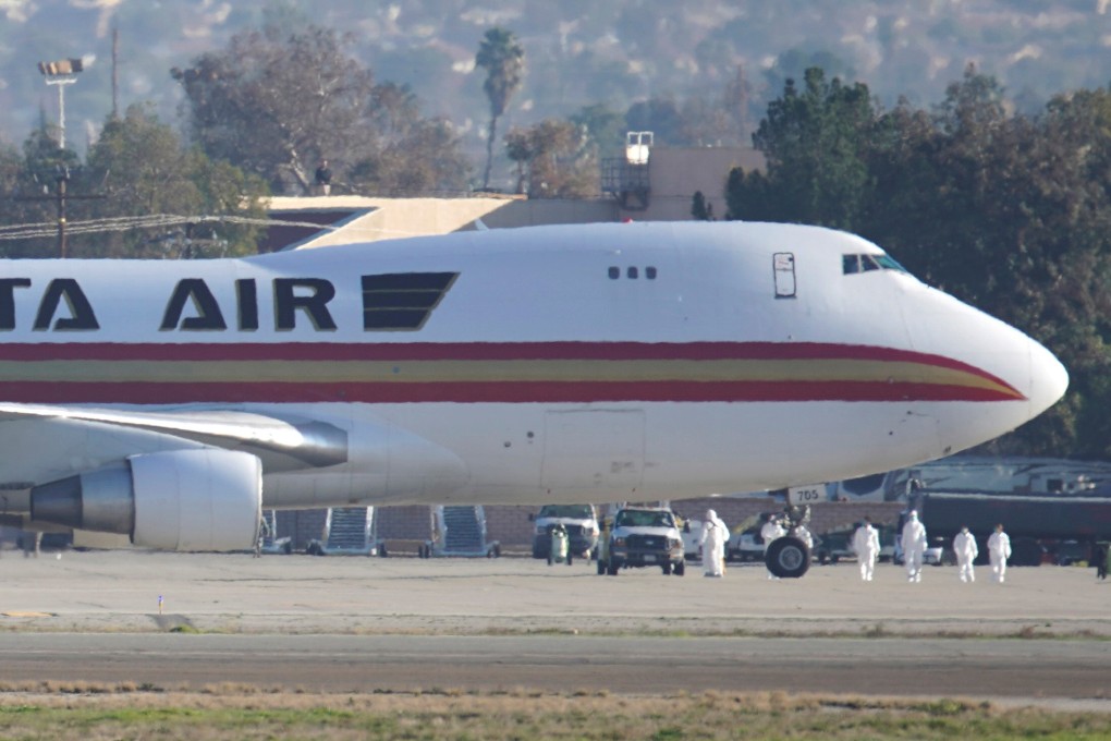 Personnel in protective clothing approach the aircraft carrying evacuated US citizens from Wuhan after it arrived at March Air Reserve Base in California on Wednesday. Photo: Reuters